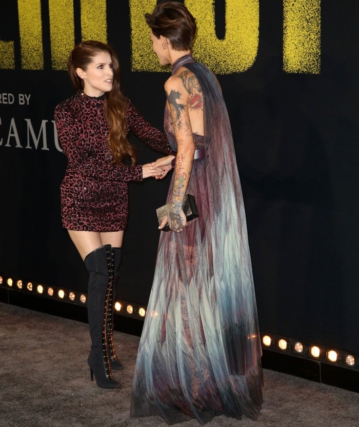 Standing at 5 ft 6½ in (168.9 cm), Ruby Rose towers over 5 ft 1 in (154.9 cm) Anna Kendrick as the two co-stars share a stylish red-carpet moment in contrasting silhouettes — Anna in a glittering mini dress and thigh-high boots, Ruby in a flowing Elie Saab gown