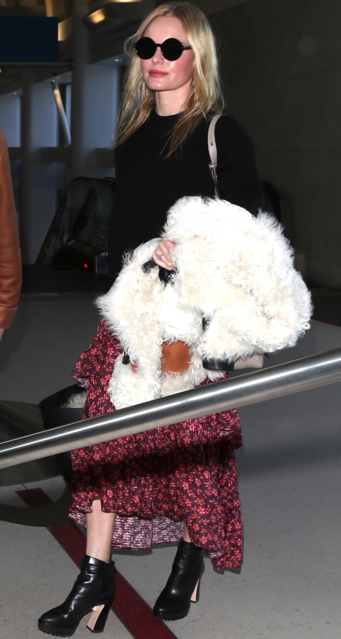 Kate Bosworth is carrying a cozy shearling jacket and a large black tote bag