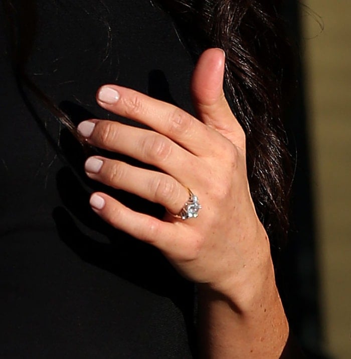 Meghan Markle's Cleave Company engagement ring features a cushion diamond and a pair of round side stones on a gold band