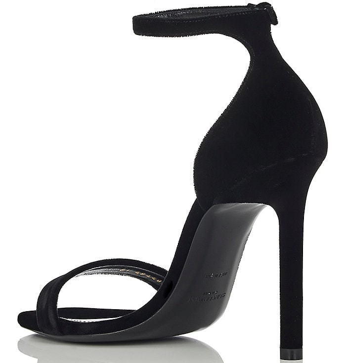 Saint Laurent’s iconic “Amber” black velvet sandals feature a minimalist silhouette with a slim ankle strap, open toe, and stiletto heel that make them a timeless red-carpet favorite