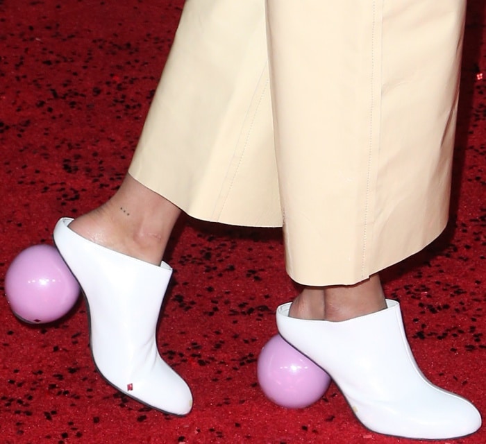 Tessa Thompson makes a bold statement with her sculptural white mules featuring unique pink spherical heels