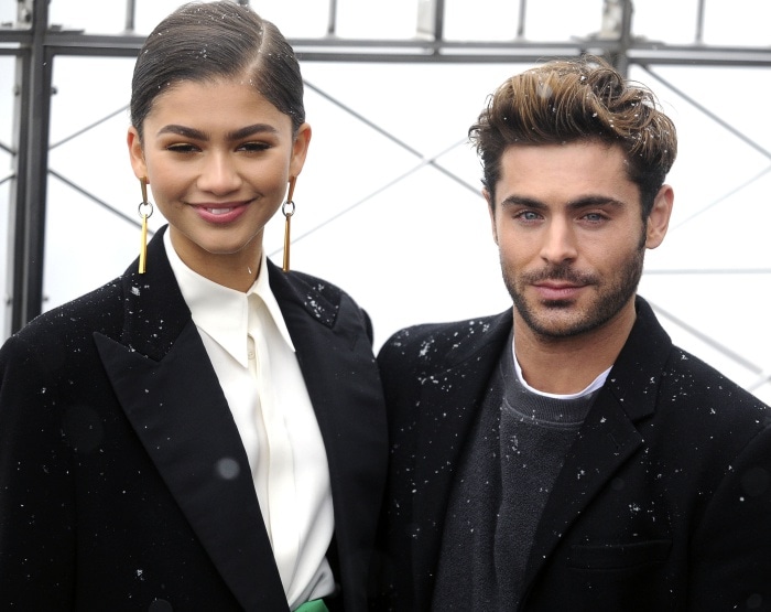Zendaya appears taller than Zac Efron as the The Greatest Showman co-stars pose together during the Empire State Building lighting ceremony