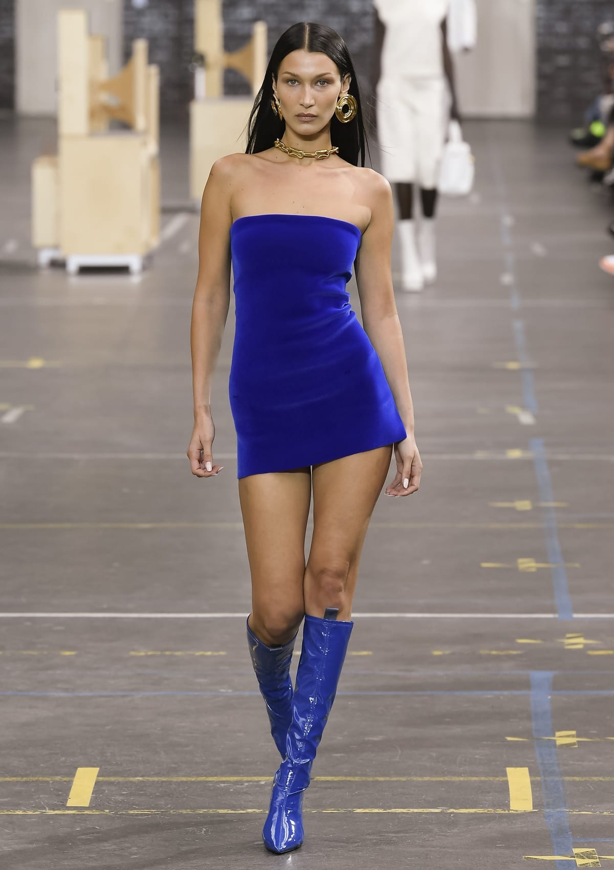 Model Bella Hadid showcases the Off-White Fall 2021 Ready-to-Wear collection on the catwalk in Paris on July 4, 2021, featuring striking blue knee-high boots, a testament to Virgil Abloh's visionary design