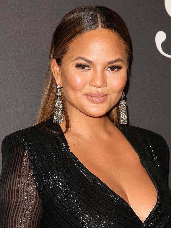 Chrissy Teigen glows with a soft nude lipstick that enhances her natural beauty