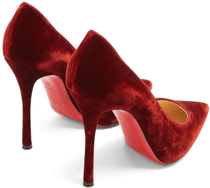 Christian Louboutin's burgundy velvet 'Decoltish' pumps are crafted in Italy with a sharp point toe and sultry curved high stiletto heel
