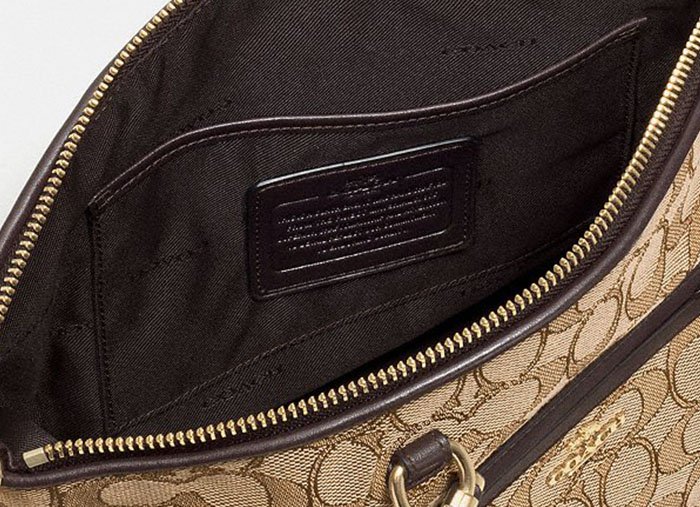 The creed patch includes a paragraph of embossed text and a unique serial number — key authenticity indicators found inside most full-sized Coach handbags