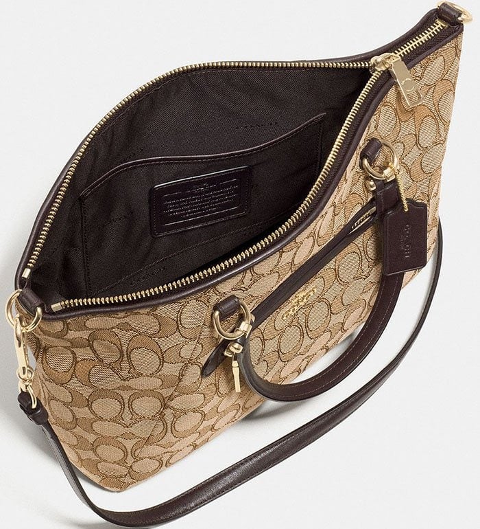 The interior of a classic Coach monogram tote features a creed patch, gold zipper, and clean stitching — signs of authentic design and premium quality control