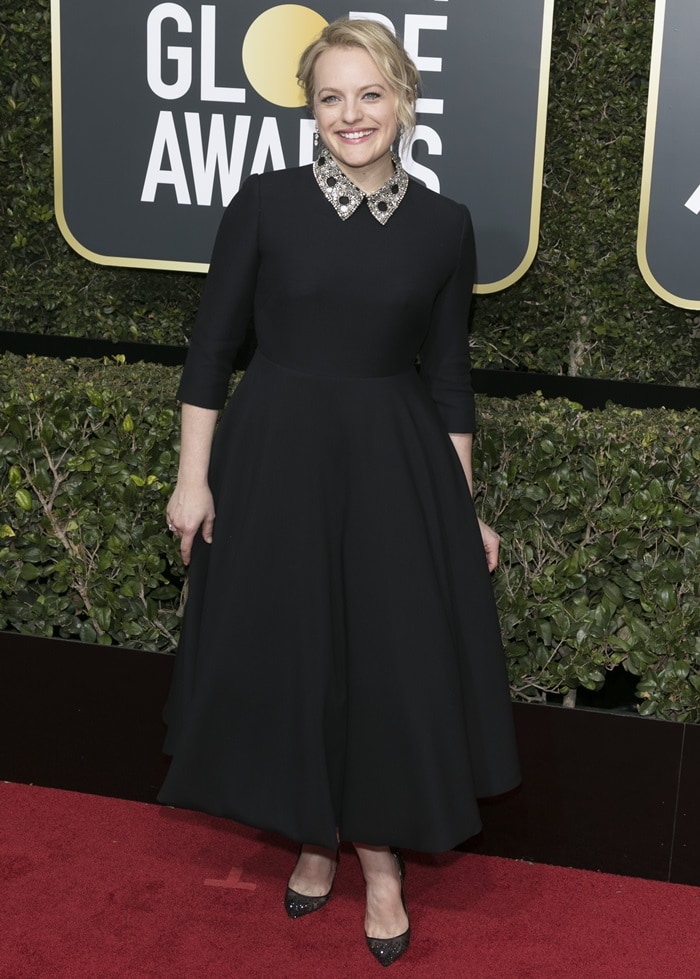 Elisabeth Moss accessorized with Forevermark jewels, a Roger Vivier clutch, and glittering Christian Louboutin pointy-toe lace pumps