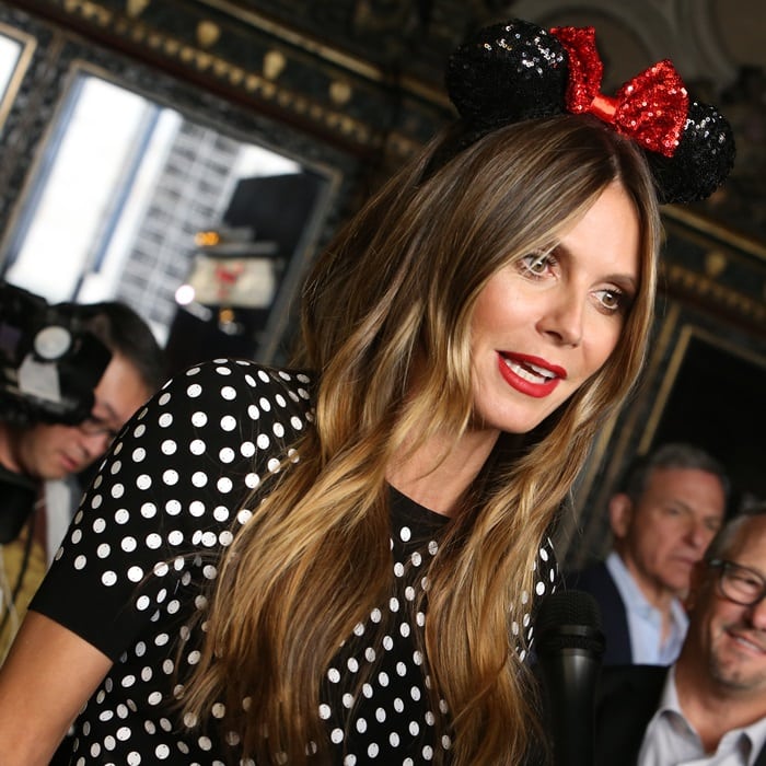 Heidi Klum embraces the Disney spirit in a polka-dot dress and sequined Minnie Mouse ears