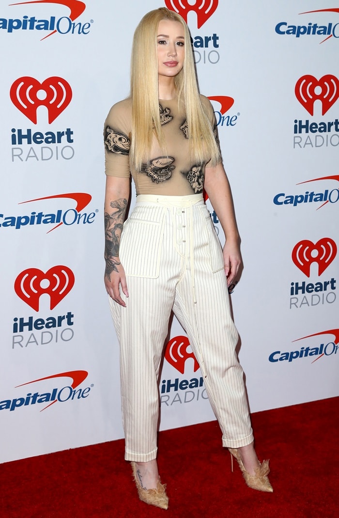 Iggy Azalea rocking quirky white pinstripe pants with Toufrou pumps