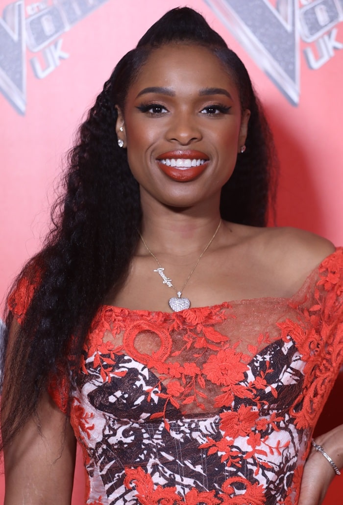 Jennifer Hudson radiated confidence in a vibrant off-the-shoulder lace dress at The Voice UK launch photocall, pairing the bold look with glowing makeup and a sparkling nameplate necklace