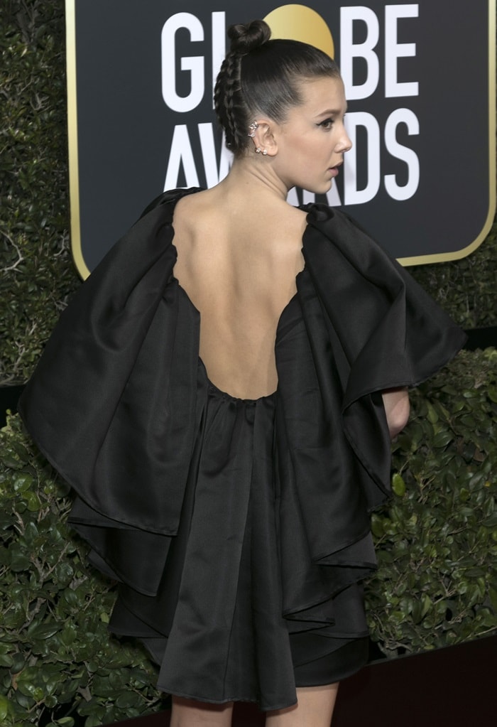 Millie Bobby Brown makes a statement in a backless Calvin Klein by Appointment dress featuring dramatic ruffle detailing