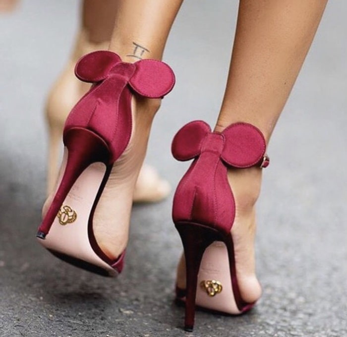 These feminine burgundy Oscar Tiye 'Minnie' heels with playful mouse-ear details add a unique, stylish flair to any outfit, perfect for making a statement