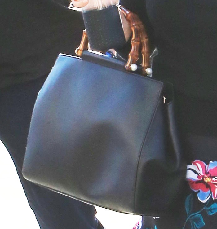 The actress shows off her luxurious Gucci "Nymphaea" bamboo medium leather tote