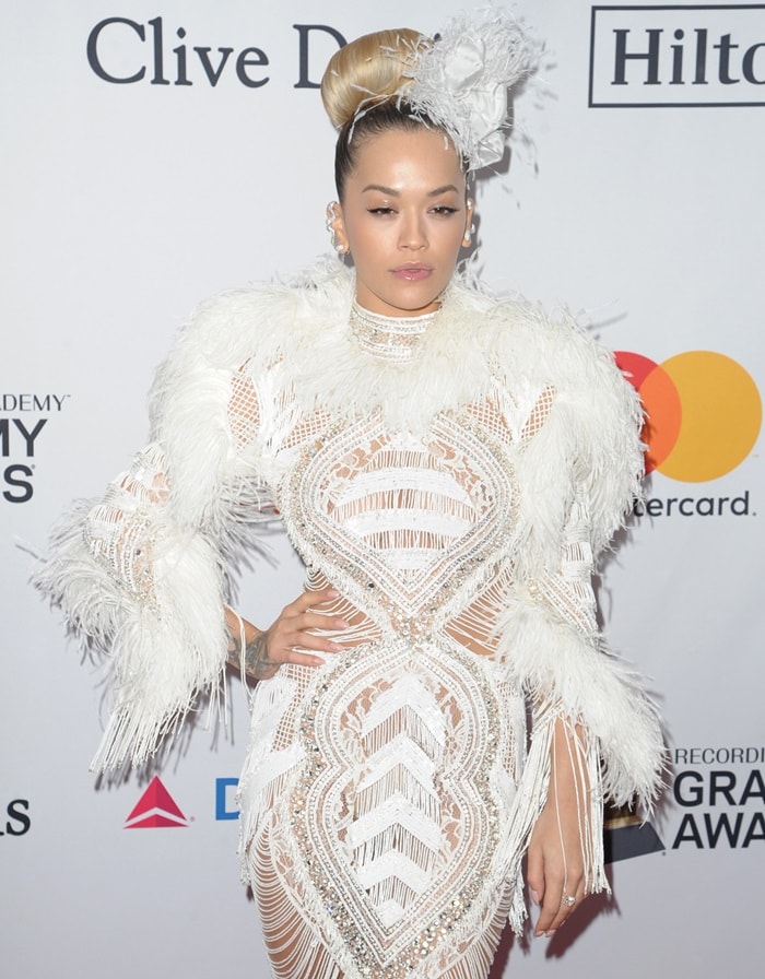 Rita Ora stuns at Clive Davis' Pre-Grammy Gala in a beaded, feathered Zuhair Murad Fall 2017 Couture dress, complemented by a sleek updo adorned with a feathered headpiece