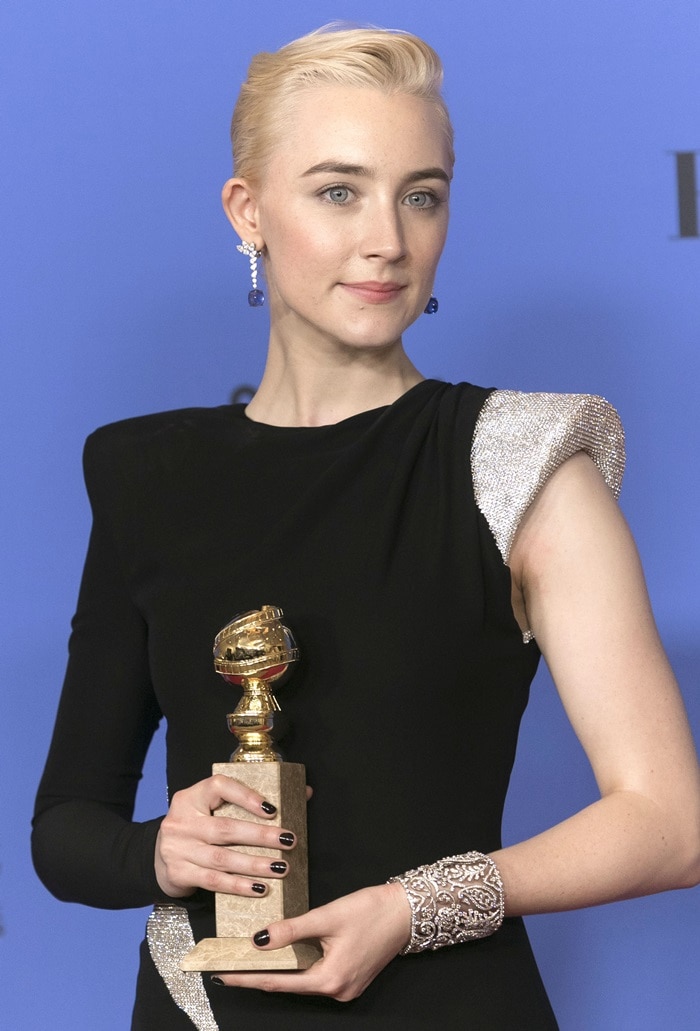 Saoirse Ronan wearing a black Atelier Versace asymmetrical gown featuring Swarovski crystal embellishments at the 2018 Golden Globe Awards held at the Beverly Hilton Hotel in Beverly Hills, California, on January 7, 2018