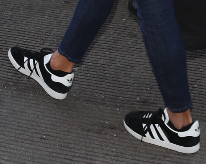 Alessandra Ambrosio wearing black and white Adidas 'Gazelle' sneakers