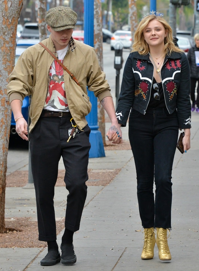 Chloë Grace Moretz adds a bold touch to her casual-chic look with gold Jimmy Choo 'Daize' boots, while Brooklyn Beckham keeps it classic in black slip-ons during their stylish outing in West Hollywood