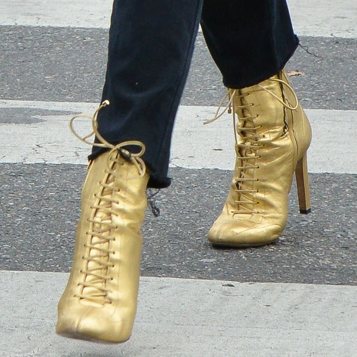 Chloë Grace Moretz steps out in striking gold Jimmy Choo ‘Daize’ boots, adding a bold, vintage-inspired touch to her birthday ensemble while elevating her monochrome look