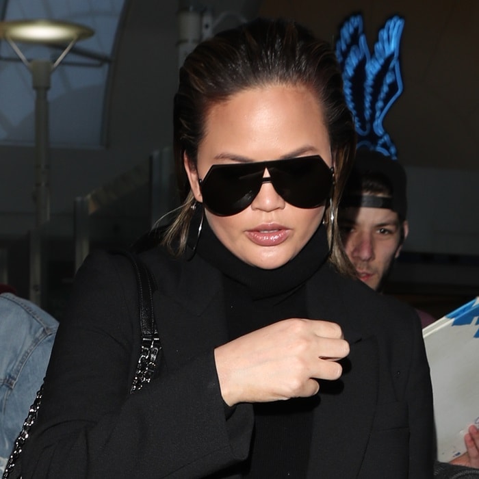 Chrissy Teigen wearing Svelte Metals 'Simone' hoop earrings and Fendi sunglasses