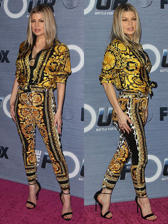 Fergie stuns in a bold gold-and-black Versace baroque print ensemble paired with Casadei Blade ankle-strap sandals at the season finale viewing party for Fox’s "The Four"