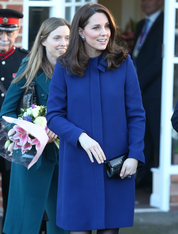 Catherine, Duchess Of Cambridge (aka Kate Middleton) wearing a marine blue Goat coat while greeting visitors at the opening of the Action On Addiction Community Treatment Centre in Wickford, England, on February 7, 2018