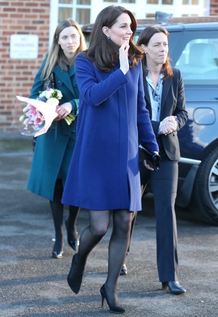 Catherine, Duchess Of Cambridge (aka Kate Middleton) greeted her fans in a blue Goat coat styled with a limited edition 'Blue Heart' clutch in black croc and her favorite 'Power' pumps from Stuart Weitzman