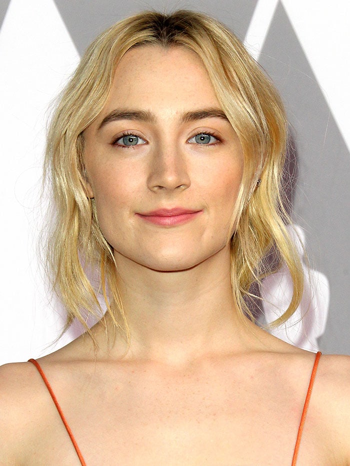 Saoirse Ronan glows with natural makeup and a soft, deconstructed ponytail at the 90th annual Oscars Nominees Luncheon