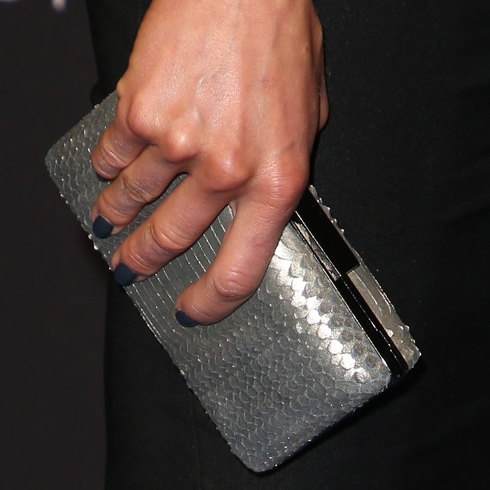 Adrianne Palicki showing off her manicure and metallic clutch