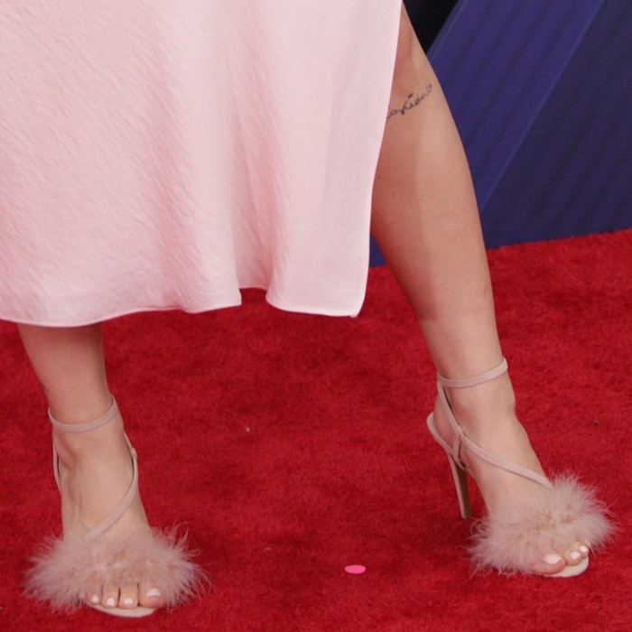 Anne-Marie’s nude Topshop “Racey” sandals combined barely-there ankle straps with soft feather detailing, adding movement and texture to her minimalist satin dress