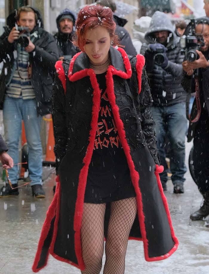 Bella Thorne braves a snowy New York day in a bold street-style look, pairing a statement “Bitch I’m Bella Thorne” graphic tee with fishnet tights and an embroidered fur-trimmed coat