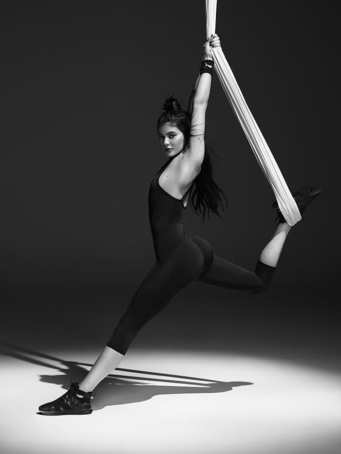 Kylie Jenner stretching with a fabric rope in the PUMA Swan Pack collection ad campaign