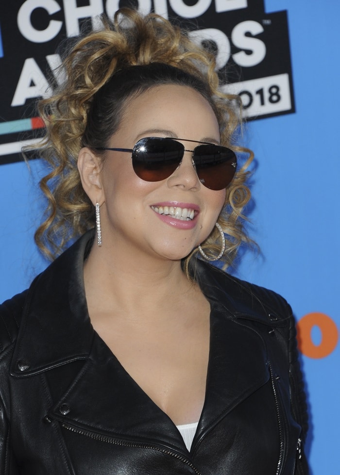 Mariah Carey rocks a playful high ponytail paired with aviator sunglasses