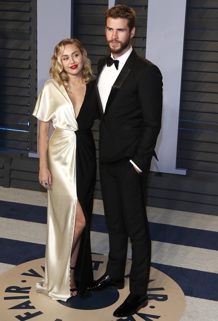 Miley Cyrus in a black and ivory silk crepe back satin v-neck column gown