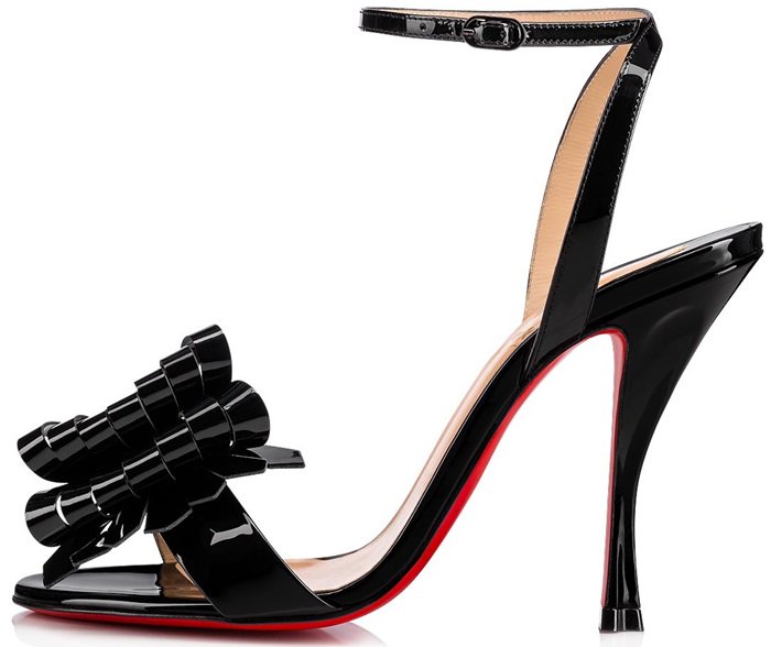 A kiltie-inspired bow adds a fresh, sculptural detail to an ankle-strap sandal set on a curvy heel