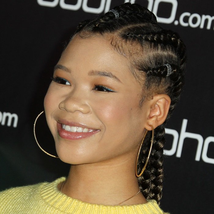 Storm Reid showcasing her statement earrings and styled hair, highlighting her unique fashion sense