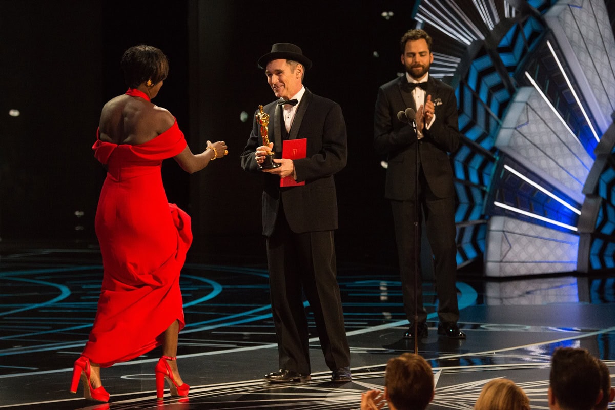 At the 89th Academy Awards on February 26, 2017, Viola Davis accepted her Oscar for Fences in a custom red Armani Privé vermillion silk gown paired with striking platform high heels that peeked through the hem as she took the stage