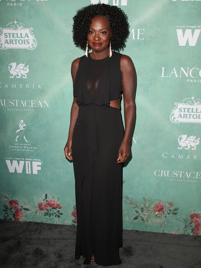Viola Davis wearing an ultra-sheer black BCBG Max Azria gown styled with silver statement earrings and high heels just peeking out at the 11th Annual Celebration of the 2018 Female Oscar Nominees presented by Women In Film in Beverly Hills, California, on March 2, 2018