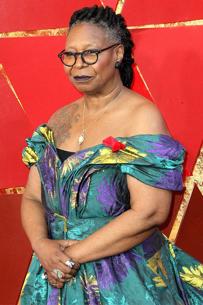 Whoopi Goldberg at the 2018 Oscars, dazzling in a custom Christian Siriano gown with metallic purple and gold leaves