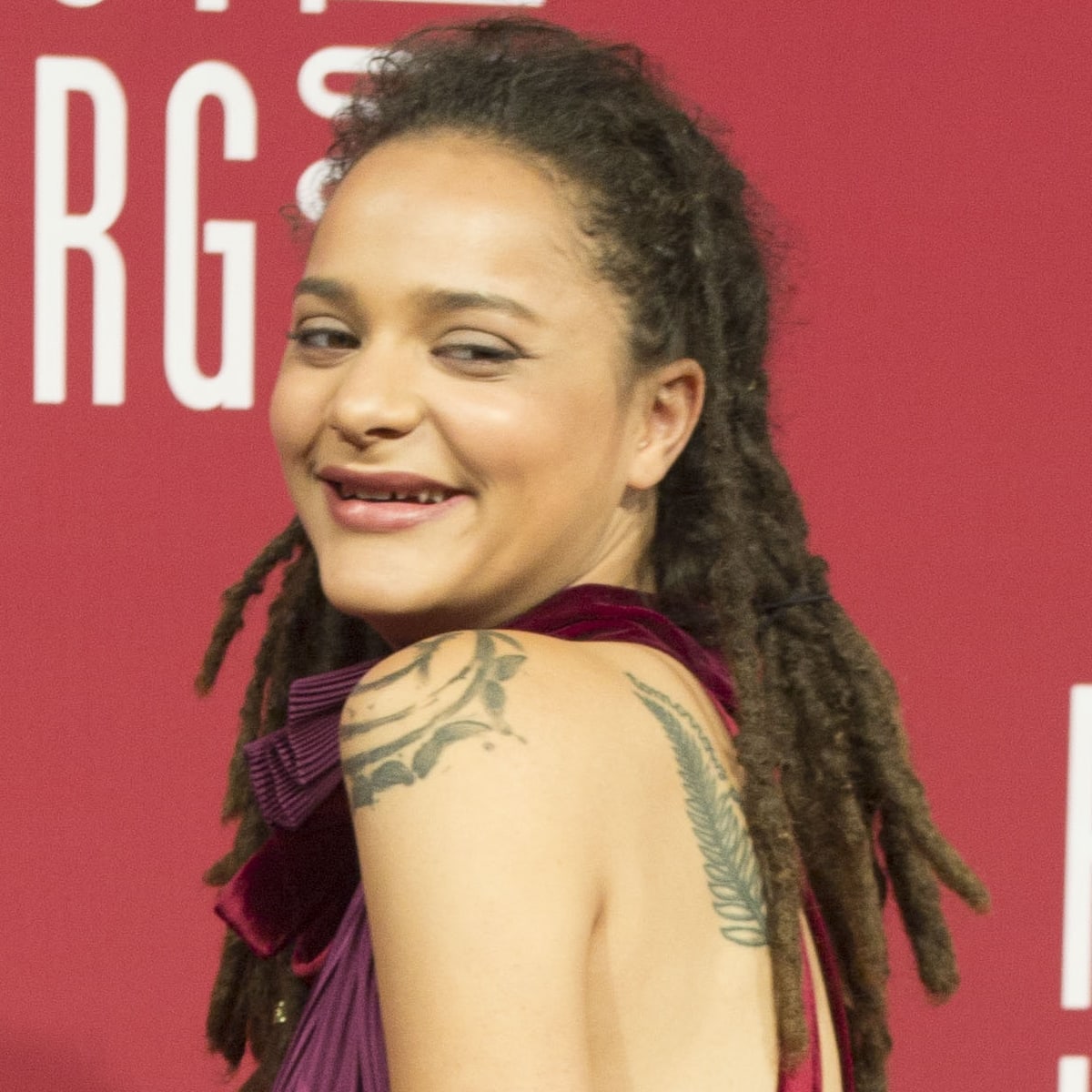 Sasha Lane's signature smile, complete with the gap between her front teeth, adds to the individuality that has made her one of Hollywood's most recognizable young actresses