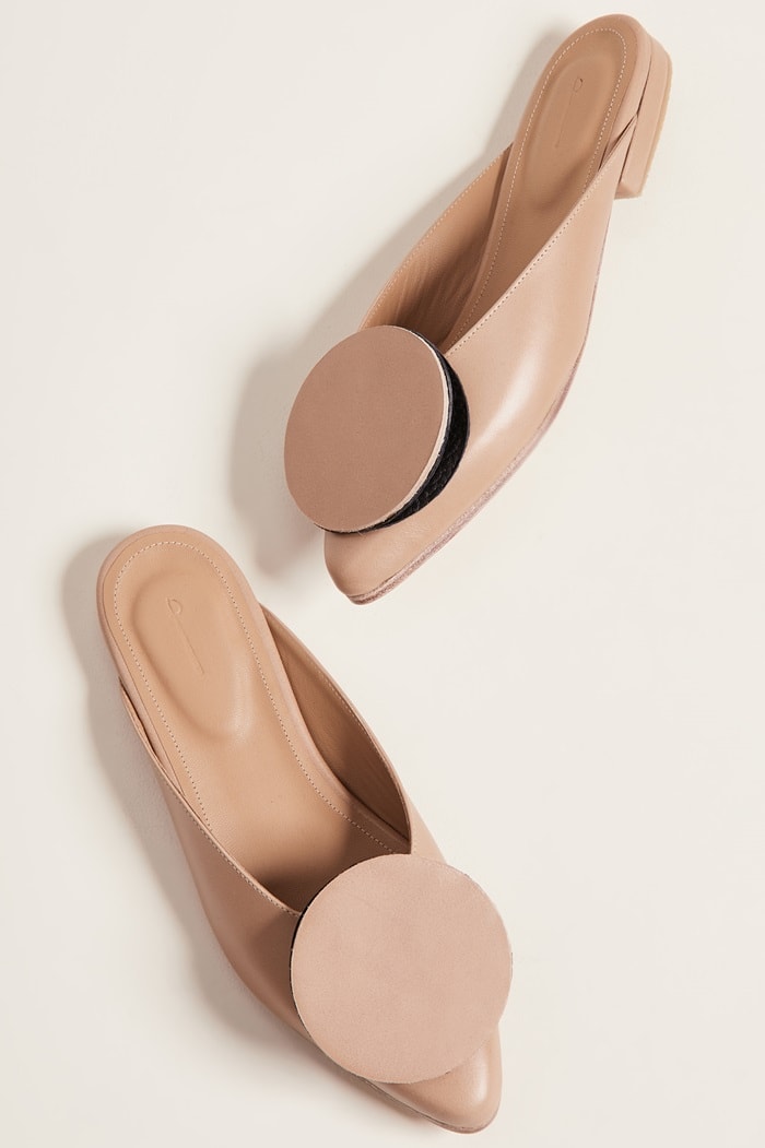These sleek leather mules by designer Jessica Taft Langdon feature a bold, circular accent that playfully evokes the look of a stylish pancake-inspired design