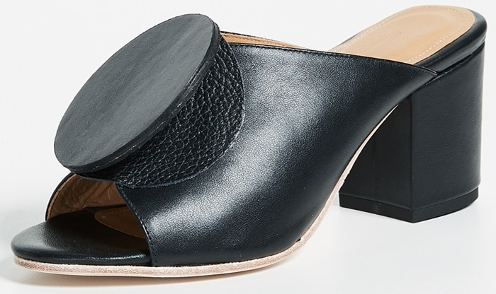 Modern, minimalist black leather mule from The Palatines with a unique circular accent and a sturdy block heel