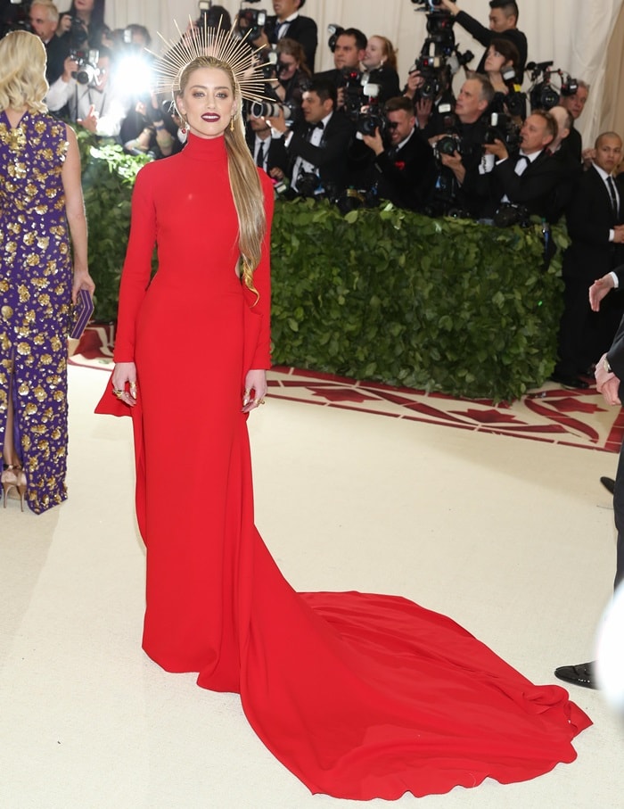 Amber Heard in a regal red long-sleeve Carolina Herrera gown