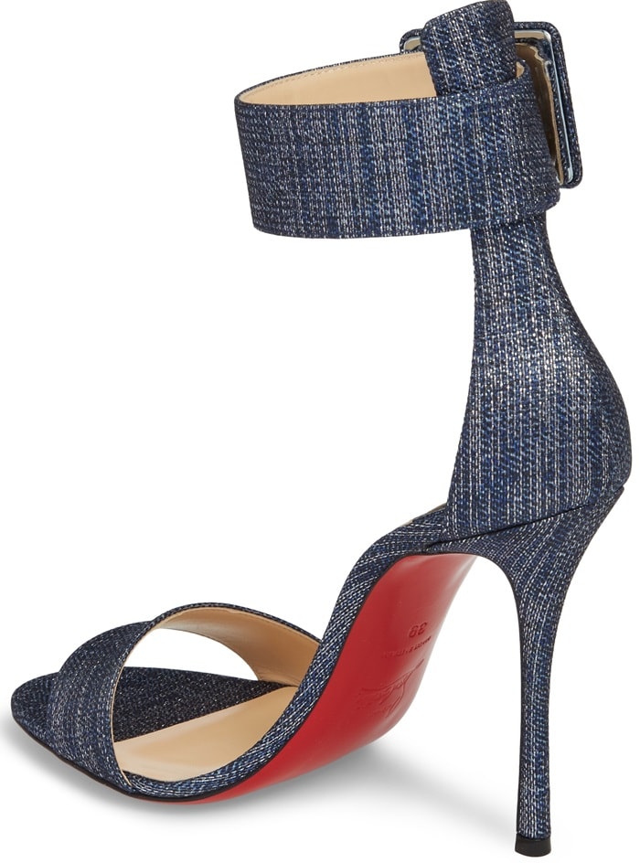 A geo-buckled ankle cuff and a curvy Cuban heel further the provocative appeal of a barely-there sandal lofted high on an impossibly slender stiletto.