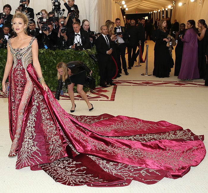 Blake Lively showing leg and Louboutin heels through the sheer panels on her Atelier Versace gown.