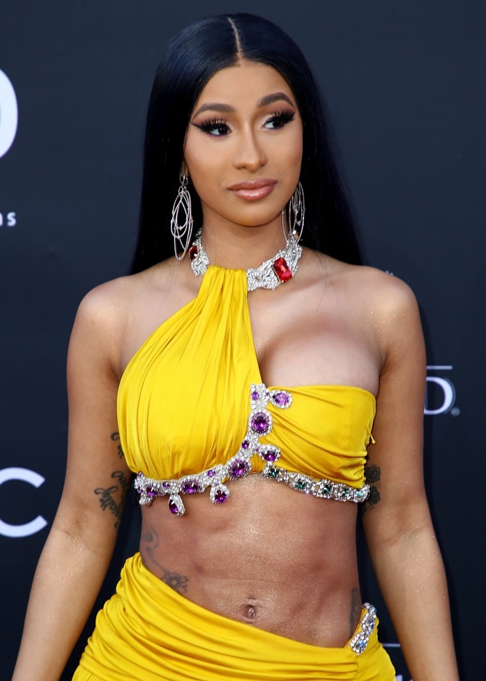 Cardi B stuns in a bold yellow Moschino ensemble adorned with crystal embellishments