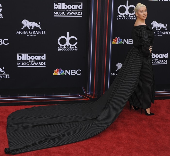 Christina Aguilera's jacket dress features a belted waist and a side train