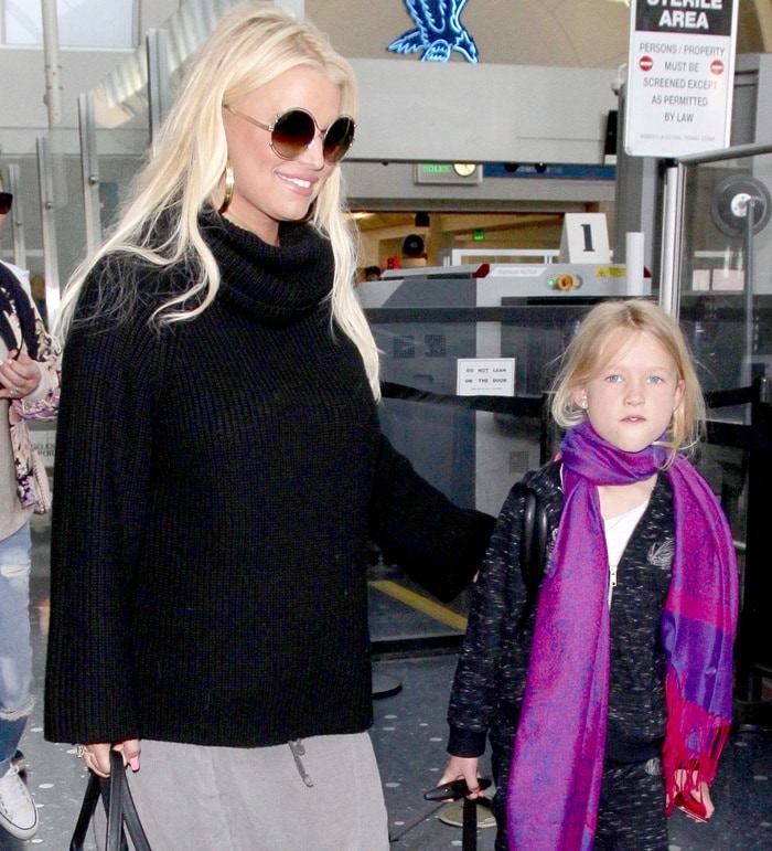 Jessica Simpson keeps it casual in a black sweater while arriving at LAX with her daughter Maxwell
