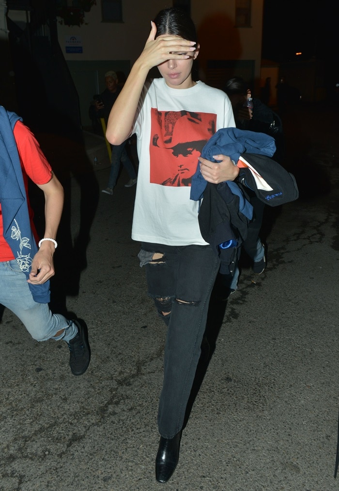 Kendall Jenner keeps things effortlessly cool in a Calvin Klein 205W39NYC x Andy Warhol Dennis Hopper T-shirt, distressed black jeans, and sleek Givenchy side-zip ankle boots as she steps out in West Hollywood