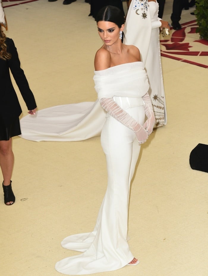 Kendall Jenner in a white bustier top with matching sheer gloves